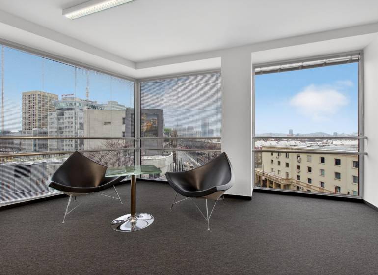 Kancelárie od 20m2 na PRENÁJOM | TOP biznis lokalita - Miestnosť s kreslami a stolíkom v kanceláriách s výhľadom na Bratislavu.