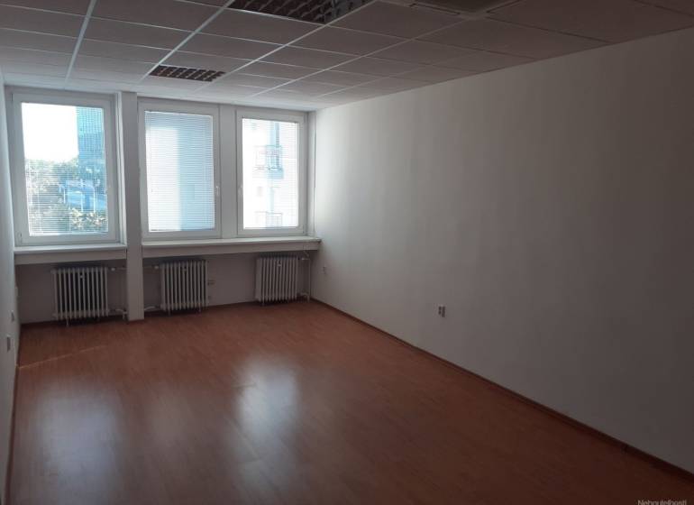 Klimatizovaná kancelária 30 m2 pri POLUS-e na Pluhovej ul. - Prázdny kancelársky priestor s podlahou s dreveným dekorom a veľkými oknami.