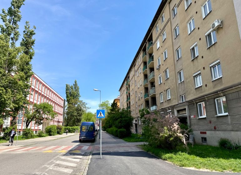 Na prenájom garsónka 19 m2, Bratislava, Ružinov, Jelačičova ulica - Ulica Jelačičova v Bratislave - Ružinov s bytovými domami a zeleňou.