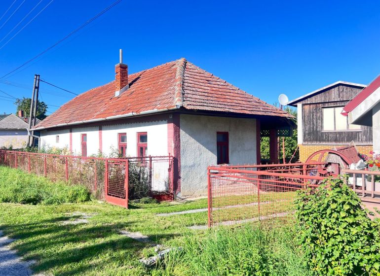 Na predaj 2 domy, ovocný raj a pokojné bývanie - Žirany D339ZL - Rodinný dom v Žiranoch, okres Nitra, s červenou strechou a plotom.