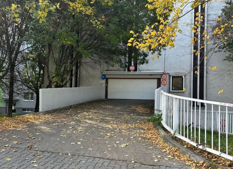 PREDAJ - Garáž na ulici Medveďovej v Petržalke - Garáže na Medveďovej ulici v Bratislave - Petržalke obklopené jesennými stromami.