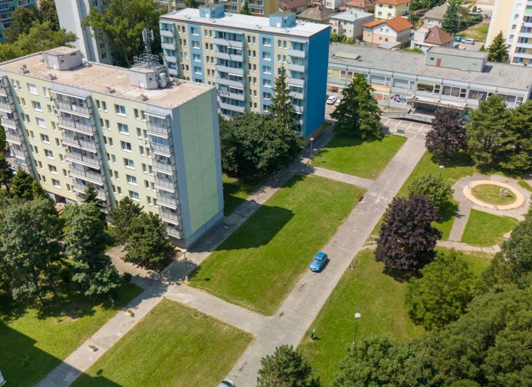 Moderne vybavený a zariadený 1-izbový byt s balkónom na sídlisku JUH - Panelové bytovky a zeleň na ulici 8. mája v Piešťanoch.