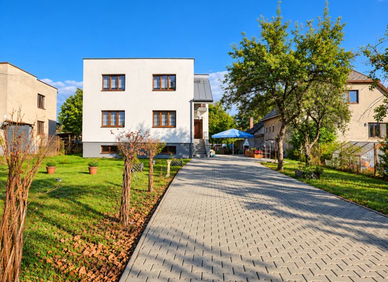 Zrekonštruovaný rodinný dom 215 m² na pozemku 1 530 m² | Martin - Rodinný dom v Martine s príjazdovou cestou a záhradou, obklopený zeleňou a stromami.