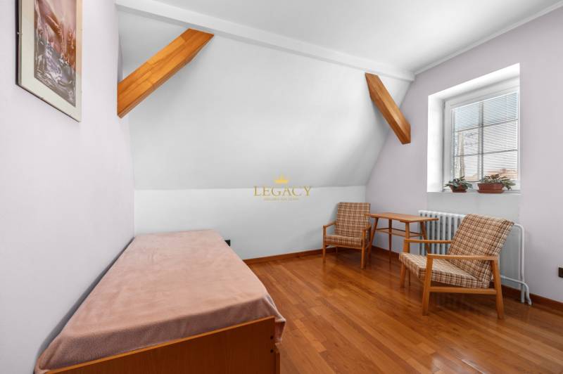 Priestranný 7-izbový dom na skok od centra – Senec - Podkrovná izba so sedačkou, kreslami a stolíkom v rodinnom dome.