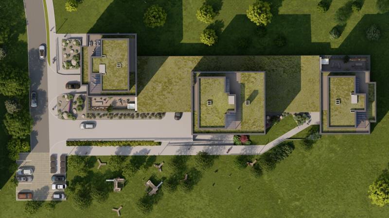 2i byt  A.3.1 - Bell Residence - Letecký pohľad na zelené strechy budov pri ulici Suchoňova, parkovisko a zeleň.