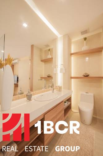 2 IZBOVÝ APARTMÁN (2 SPÁLNE + 1 OBÝV. IZBA) CITY GARDEN TOWER PATTAYA - Kúpeľňa v 3-izbovom byte s umývadlom, toaletou a dekoratívnymi policami.