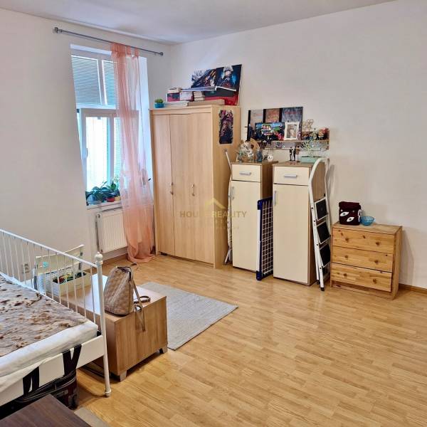 Predaj 1 izbový byt, Karpatská ulica, Bratislava I. Staré Mesto - Izba s posteľou, skrinkami a dekoráciami v 1-izbovom byte.