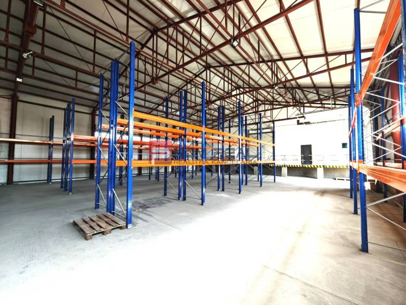 PRENÁJOM - zateplená skladová hala 547 m2, Modra - V skladoch a halách sa nachádzajú prázdne regály a paleta na podlahe.