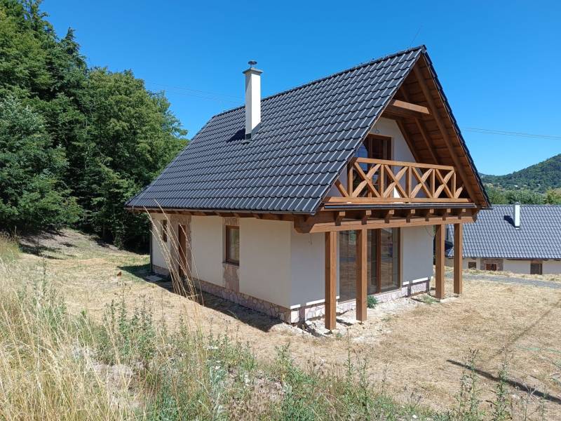 Na predaj chata novostavba  pri Novej Bani - Chata v Horných Hámroch s dreveným balkónom, obklopená prírodou a sviežou zeleňou.