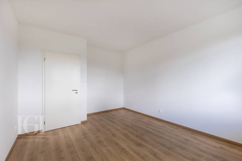 PRENAJOM | 3 Izbový byt + Loggia + Parking. PROMENADA LIVING PARK - Prázdna miestnosť s bielymi stenami a drevenou podlahou, vhodná pre 3-izbový byt.