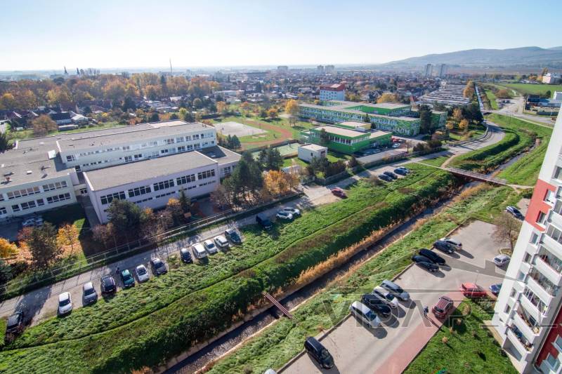 Predaj bezbariérového 3-izbového bytu v Pezinku - Výhľad zo Svätoplukovej ulice v Pezinku na priľahlé školy a parkovisko pri 3-izbovom byte.
