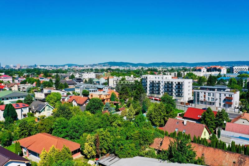 Moderný a priestranný 2i byt v novom projekte, Geologická - Letecký pohľad na domy a zeleň v Bratislave - Podunajských Biskupiciach na Geologickej ulici.