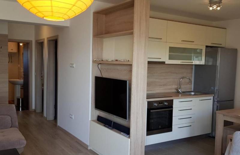 CHORVÁTSKO - Zariadený apartmán, 1. rad od mora - MANDRE, ostrov PAG - Kuchyňa v 3-izbovom byte so vstavanými spotrebičmi a televízorom na stene.