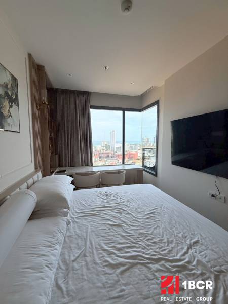 2 SPÁLŇOVÝ APARTMÁN ONCE PATTAYA - Spálňa v 3-izbovom byte s výhľadom na mesto, veľká posteľ a TV.