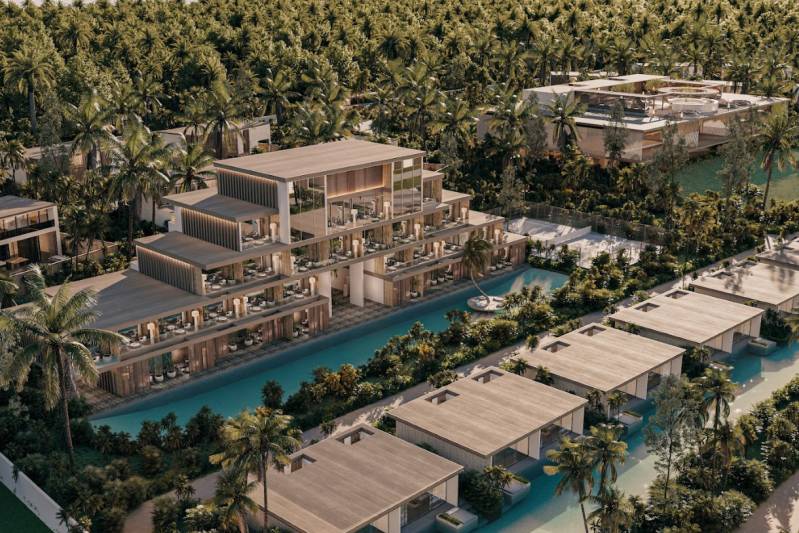HOTELOVÝ SUITE V LUXUSNOM ZANZIBARSKOM KOMPLEKSE - Rezort obklopený palmami, bazénmi a modernými budovami na predmestí.