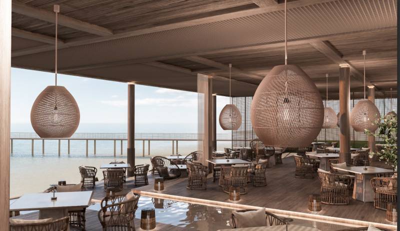 HOTELOVÝ SUITE V LUXUSNOM ZANZIBARSKOM KOMPLEKSE - Luxusná reštaurácia s výhľadom na oceán, štýlové závesné svietidlá, komfortné sedenie.
