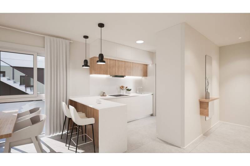 TORRE DE LA HORADADA -  nový rezidenčný komplex len 200 m od pláže - Interiér rekreačného apartmánu s kuchyňou, jedálenským stolom, zavesenými lampami a dekoráciou.