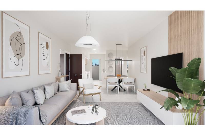 TORRE DE LA HORADADA -  nový rezidenčný komplex len 200 m od pláže - Obývacia izba v rekreačnom apartmáne so svetlými tónmi, dekoráciami a rastlinou.