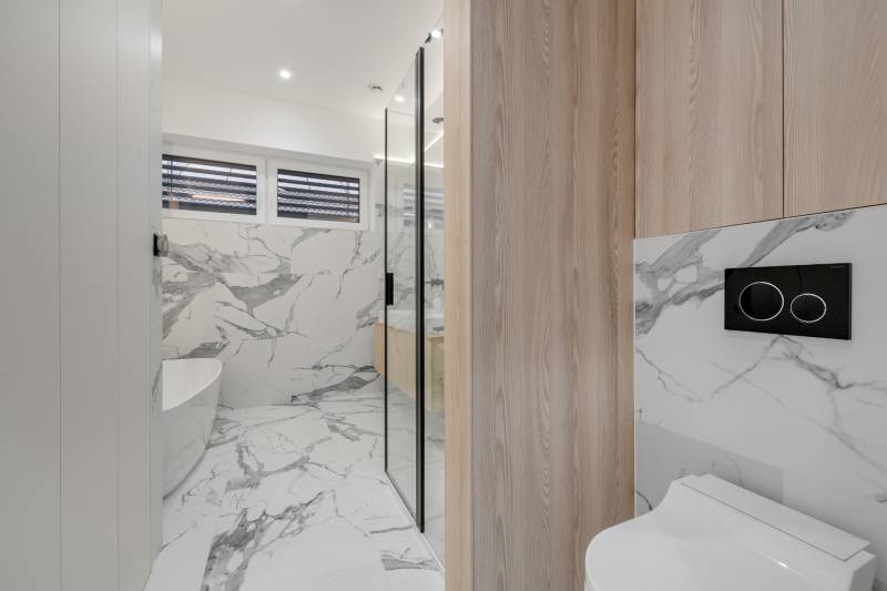THE HOME ︱ PREDAJ - designový 5-izbový rodinný dom v Chorvátskom Grob - Kúpeľňa s bielymi mramorovými obkladmi a drevenými detailmi v rodinnom dome.