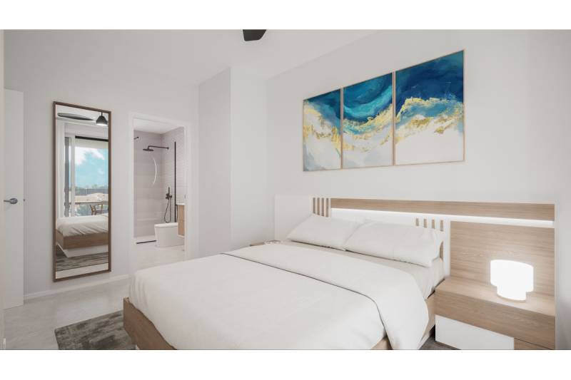 LOS ALCÁZARES -rekreačné apartmány s turistickou licenciou na prenájom - Svetlá spálňa s veľkou posteľou, obrazmi na stene a priľahlou kúpeľňou.