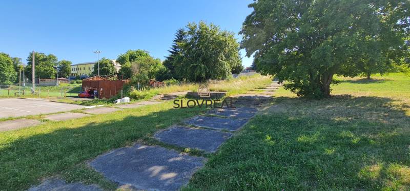 SLOVREAL predaj pozemku Žiar nad Hronom - Zeleň a stromy pri pozemkoch na bývanie v Žiari nad Hronom v letnom počasí.
