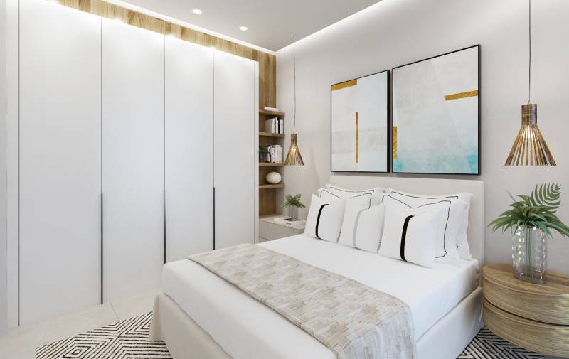 SANTA ROSALIA - Luxusné apartmány s 2 -3 spálňami s výhľadom na jazero - Svetlá spálňa v 3-izbovom byte s bielymi skriňami a farebnými obrazmi.