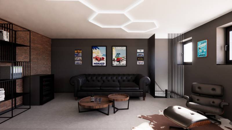 Exkluzívne garáže v projekte PARK3BA, Triblavina, Bratislava - Kožená sedačka v obchodných priestoroch s vintage dekoráciami na stene.