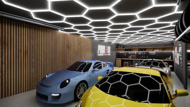 Exkluzívne garáže v projekte PARK3BA, Triblavina, Bratislava - Obchodné priestory so zaparkovanými športovými autami a moderným osvetlením na strope.