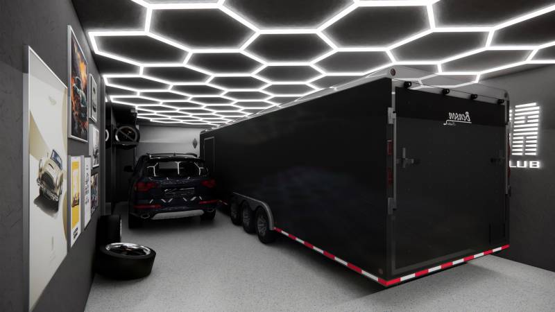 Exkluzívne garáže v projekte PARK3BA, Triblavina, Bratislava - Obchodné priestory s automobilom, prívesom, svetelným stropom a umeleckými plagátmi na stene.