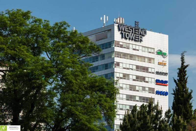 Moderné kancelárske priestory vo Westend Tower - Budova Westend Tower medzi stromami na Dúbravskej ceste v Bratislave - Karlovej Vsi.