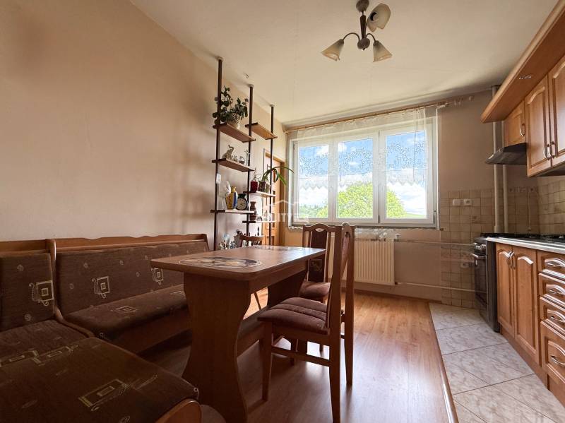 Na prenájom, 5-izbový rodinný dom s pozemkom 2225 m2, Papradno - Rodinný dom s kuchyňou obsahujúcou drevený nábytok, jedálenský stôl a poličku s dekoráciami.