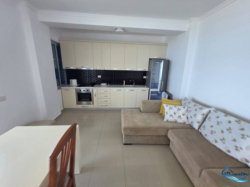 Sarandë - zariadený apartmán s otvoreným výhľadom na more - Rekreačný apartmán s kuchynskou linkou, pohovkou a jedálenským stolom.
