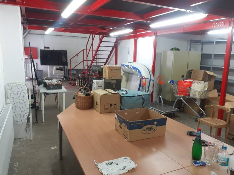 Prenájom skladu 150 m2 pri Zlatých pieskoch na Studenej ul. - Interiér skladov a hál s kartónmi, stolmi a červenými schodmi.