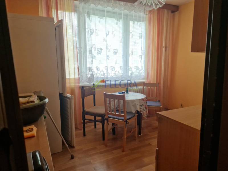 REZERVOVANÝ- 1-izbový byt, Košice, Ružová ulica - Kuchyňa v 1-izbovom byte so stolom, stoličkami a chladničkou.