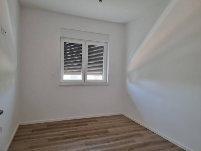 CHORVÁTSKO - Pekné apartmány 350m od pláže (S3) - VODICE - Interiér 4-izbového bytu s bielymi stenami a drevenou podlahou.