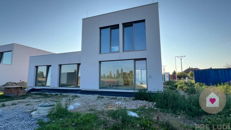 Kráľova pri SENCI-Novostavba 2-podlažného RD s hlinikovými oknami - Rodinný dom v Kráľovej pri Senci na Réckej ulici so sklenenými stenami a neudržiavanou záhradou.