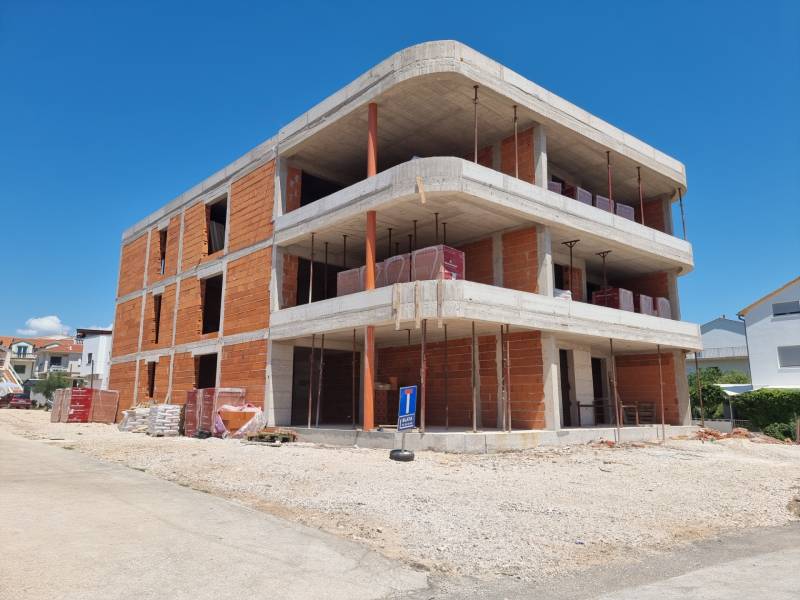 CHORVÁTSKO - Apartmány 140 m od pláže (3i) - VODICE - Rozostavaná budova so 3-izbovým bytom v meste Vodice za slnečného dňa.