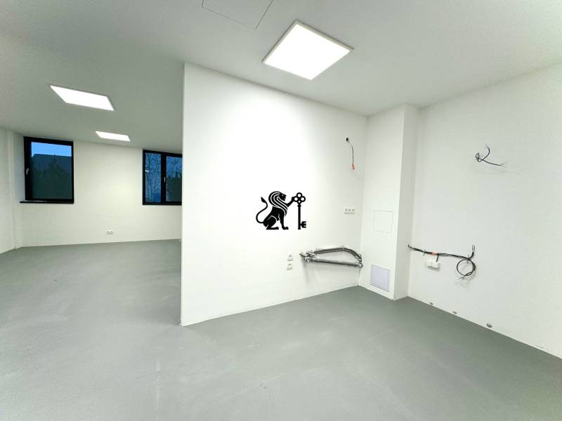 Budova s 8 apartmánmi alebo medicínske centrum, 9 park. miest- Kolibe - Biela miestnosť na ulici Na varte v budove so sivou podlahou a čiernou dekoráciou.