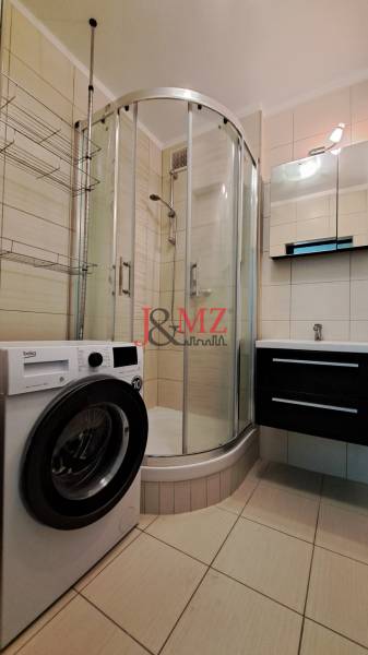 2 izbový byt 65 m2, kompletná rekonštrukcia, Tlmače-Lipník (SM-836) - Kúpeľňa v 2-izbovom byte so sprchovacím kútom, umývadlom a práčkou.
