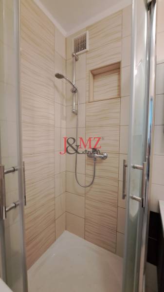 2 izbový byt 65 m2, kompletná rekonštrukcia, Tlmače-Lipník (SM-836) - Sprchový kút v 2-izbovom byte s obkladmi krémovej farby a sklenenými dverami.