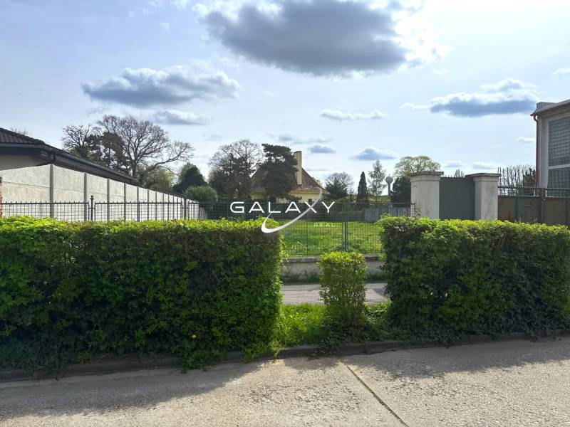 Pozemok 1315 m² pre rodinný dom blízko centra – Sládkovičovo - Pozemky - bývanie v Sládkovičove, za zeleným plotom sa nachádza priestranná lúka.