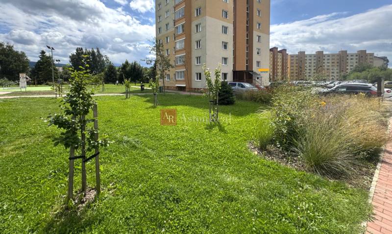 Pripravujem do ponuky!!! 2-izbový byt v Trstenej, Západ, 50m2, loggia - Trávnatá plocha pred bytovým domom na ulici Západ v Tvrdošíne obklopená zeleňou a parkoviskom.