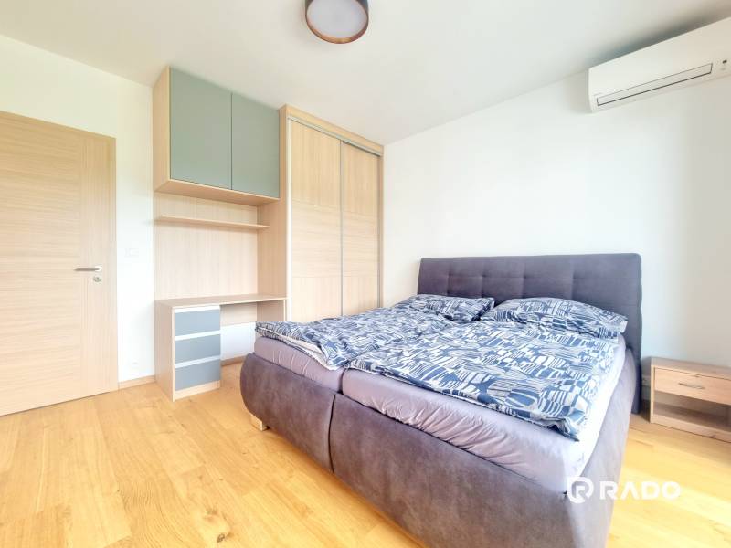 | EXKLUZÍVNE! | Krásny NOVÝ 2-izbový byt | 48m² | Čerešne - Spálňa v 2-izbovom byte s posteľou, vstavanou skriňou a klimatizáciou.