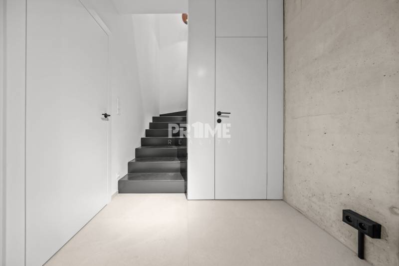 EXKLUZÍVNY MEZONETOVÝ 4i byt ( 103 m2 ), NADSTAVBA, KLÍMA, LOGGIA,NIVY - Minimalistické schodište v 4-izbovom byte s bielymi stenami na ulici Páričkova.