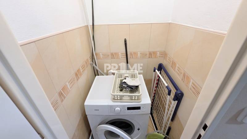 Pekný 2i byt, REKONŠTRUKCIA, Vajanského nábrežie, Staré Mesto - Práčka s vešiakom a doplnkami v komore 2-izbového bytu.