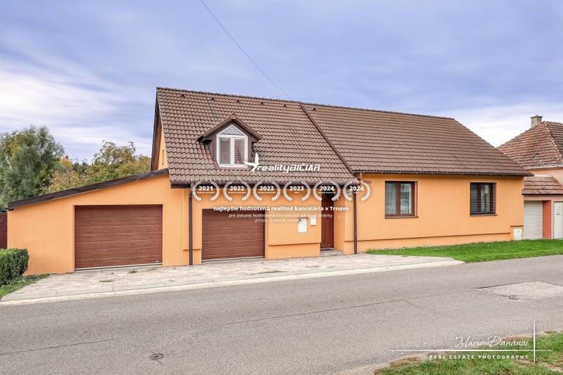 5-izbový rodinný dom s dvomi garážami v obci Špačince - Rodinný dom na ulici Špačince v Špačinciach so šikmou strechou a garážou.