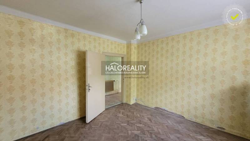 Predaj, rodinný dom Sľažany - EXKLUZÍVNE HALO REALITY - Interiér rodinného domu s žltými tapetami a drevenou podlahou.