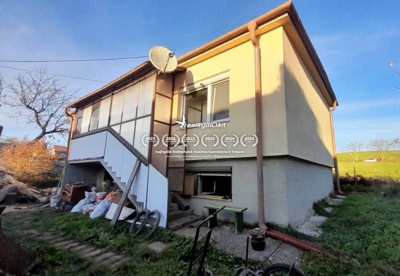 Rodinný dom v obci Dobrá Voda  - Rodinný dom v Dobrá Voda so schodiskom, záhradou a satelitnou anténou na dvore.