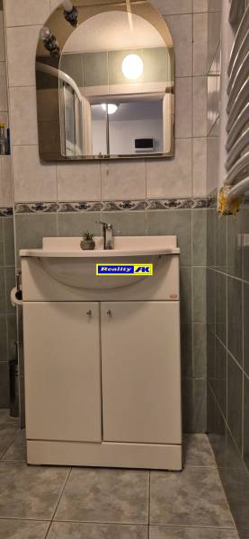 REZERVOVANÉ jednoizbový zrekonštruovaný byt v širšom centre mesta - Kúpeľňa s umývadlom a zrkadlom v 1-izbovom byte, s keramickými obkladmi.