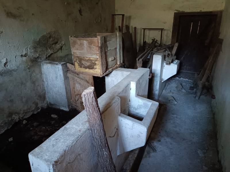 Hospodárska usadlosť s 3,6 hektárovým pozemkom na samote Nová Baňa - Staré miestnosti v rodinnom dome s drevenými debnami a betónovými blokmi.